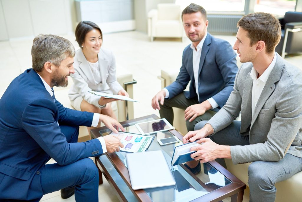 team-of-cheerful-business-people-in-meeting-e1619632345114